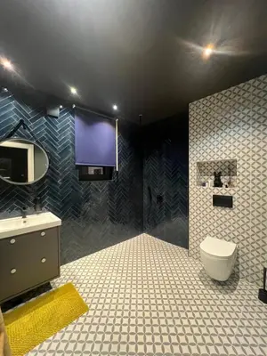 a bathroom with a toilet and a tv on the wall at Sunny Apart in Budva