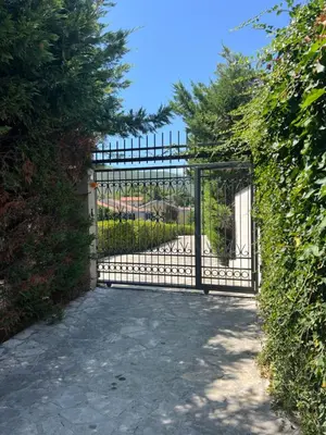 a gate to a garden with a driveway at Sunny Apart in Budva