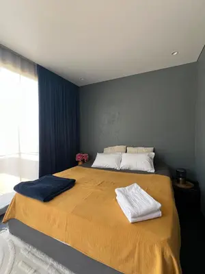 a bedroom with a large bed with two towels on it at Sunny Apart in Budva