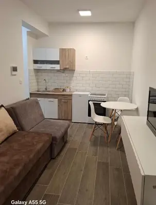 a living room with a couch and a table at ZEN Studio Apartman in Kotor