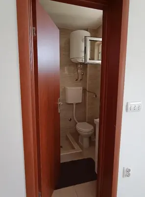 a small bathroom with a toilet and a microwave at Jasmin 3 in Ulcinj