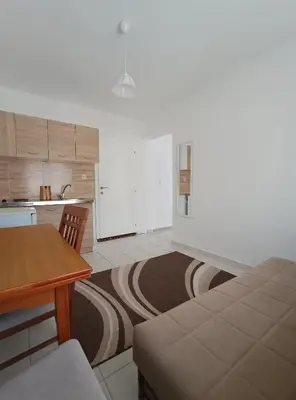a kitchen with a bed and a table in a room at Jasmin 3 in Ulcinj