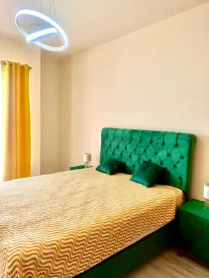 a bedroom with a large bed with a green headboard at Sunny Hills Apartment in Seoca