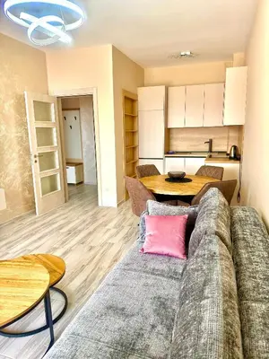 a living room with a couch and a table at Sunny Hills Apartment in Seoca