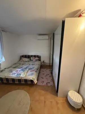 a small bedroom with a bed and a closet at Apartman Adea in Donji Štoj
