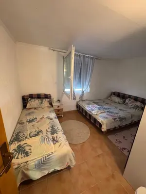 a bedroom with two beds and a window at Apartman Adea in Donji Štoj