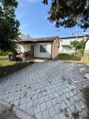 a brick driveway in front of a house at Apartman Adea in Donji Štoj