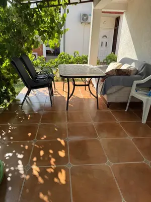 a patio with a table and chairs and a couch at Apartman Adea in Donji Štoj