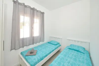 two beds in a white room with a heart pillow at Holiday Home Stanka in Kotor