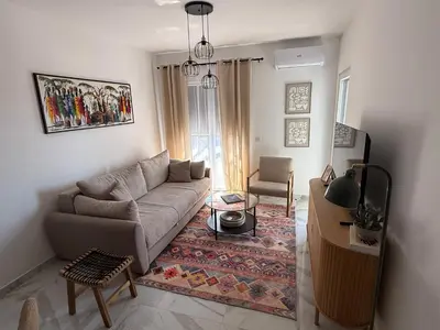 a living room with a couch and a table at Stylish Coastal Apartment in Kotor