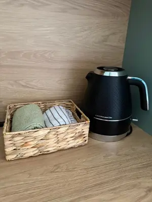a basket of towels and a tea kettle on a counter at Stylish Coastal Apartment in Kotor