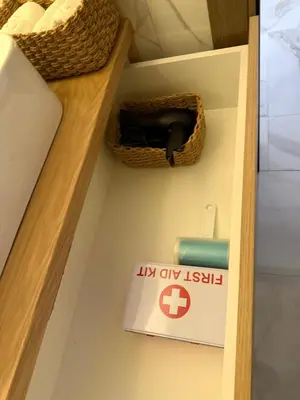 a sign on a shelf in a room with a drawer at Stylish Coastal Apartment in Kotor