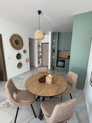 a dining room with a wooden table and chairs at Stylish Coastal Apartment in Kotor