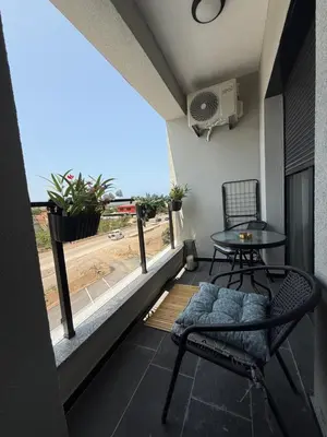 a balcony with a table and chairs and a window at Stylish Coastal Apartment in Kotor