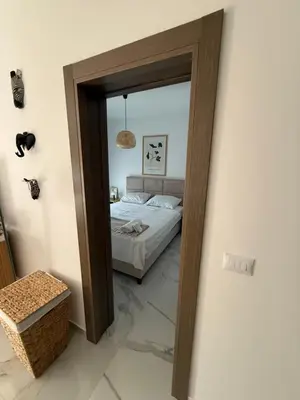 a mirror in a bedroom with a bed in it at Stylish Coastal Apartment in Kotor
