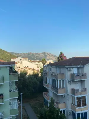 an apartment building with balconies on the side of it at Budva in Budva