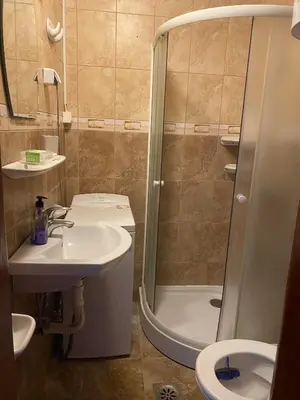 a bathroom with a shower and a sink and a toilet at Budva in Budva