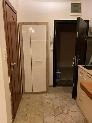 a kitchen with a door open to a kitchen with a refrigerator at Budva in Budva