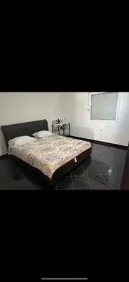 a large bed in a room with a window at Agron apartments in Ulcinj