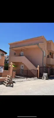 a building with a fence in front of it at Agron apartments in Ulcinj