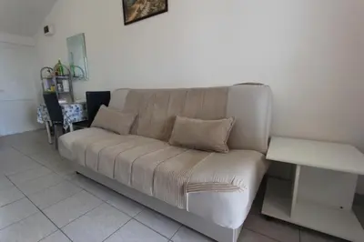 a couch sitting in a living room at Apartman Ksjusa in Sutomore