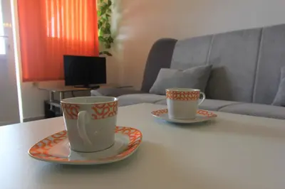 two coffee cups and saucers sitting on a table at Apartman Ksjusa in Sutomore