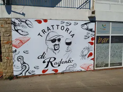 a wall with a painting of a man holding a glass of wine at Apartman Ksjusa in Sutomore