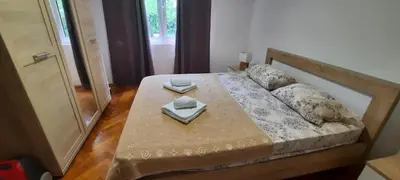 a bedroom with a bed with two dishes on it at Two Bedrooms Apartment With Garden View in Budva