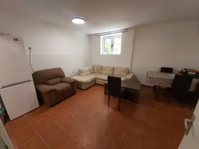 a living room with a couch and a table at Two Bedrooms Apartment With Garden View in Budva