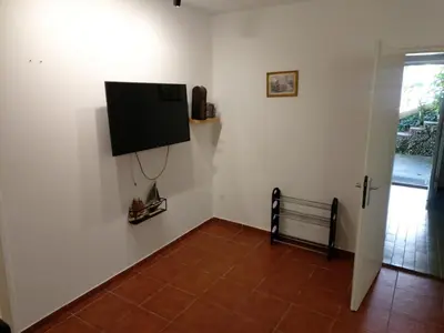 a room with a flat screen tv on a wall at Two Bedrooms Apartment With Garden View in Budva