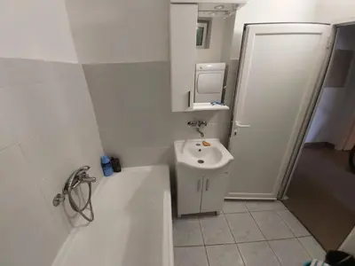 a bathroom with a sink and a tub and a toilet at Two Bedrooms Apartment With Garden View in Budva