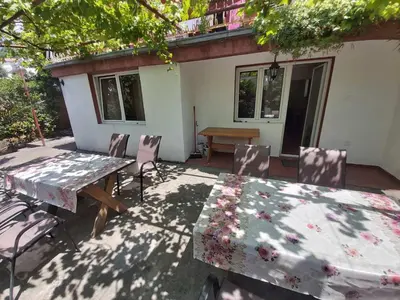 a patio with a table and chairs and a table and a table and chairsktop at Two Bedrooms Apartment With Garden View in Budva