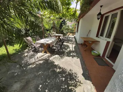 a patio with a table and chairs next to a house at Two Bedrooms Apartment With Garden View in Budva