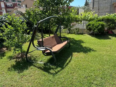 a swing sitting in the grass in a yard at Holiday Home Vesna in Budva