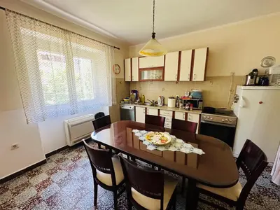 a kitchen with a table and chairs and a refrigerator at Holiday Home Vesna in Budva