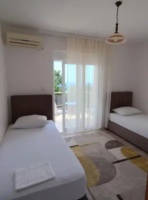 a bedroom with two beds and a view of a patio at Jasmin 4 in Ulcinj