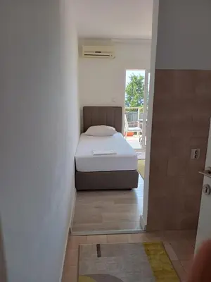 a bedroom with a bed in the corner of a room at Jasmin 4 in Ulcinj