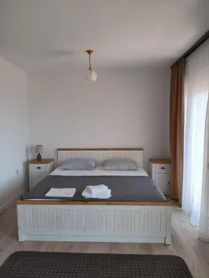 a bedroom with a large white bed in a room at Suzana in Ulcinj