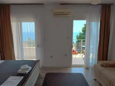 a bedroom with a bed and a door to a patio at Suzana in Ulcinj
