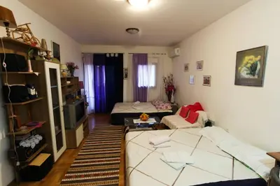 a living room with a couch and a bed at Jelena in Budva