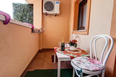 a small room with a table and chairs and a window at Jelena in Budva