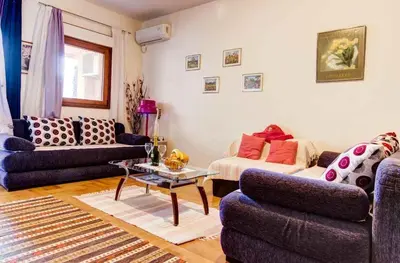 a living room with two couches and a table at Jelena in Budva