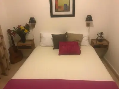 a bedroom with a bed with a red pillow on it at Villa ALEA in Dobra Voda