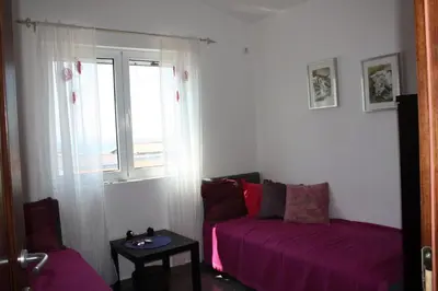 a living room with a couch and a window at Villa ALEA in Dobra Voda