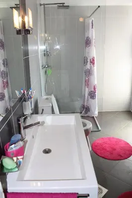 a bathroom with a white sink and a shower at Villa ALEA in Dobra Voda