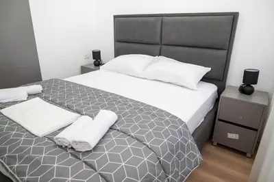a bedroom with a large bed with towels on it at Urban Coast - Ulcinj Apartment in Ulcinj