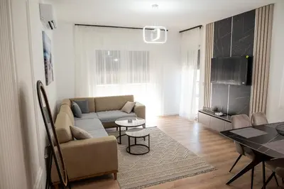a living room with a couch and a table at Urban Coast - Ulcinj Apartment in Ulcinj