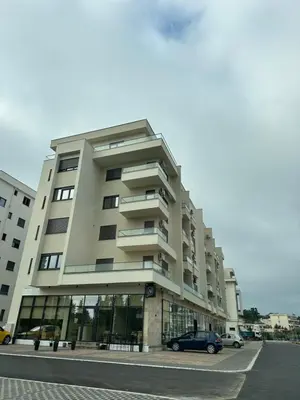a building with a car parked in front of it at Urban Coast - Ulcinj Apartment in Ulcinj