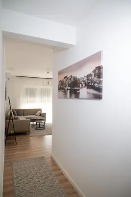 a living room with a couch and a painting on a wall at Urban Coast - Ulcinj Apartment in Ulcinj