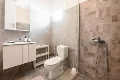a bathroom with a toilet and a shower at Harmony Point in Bar